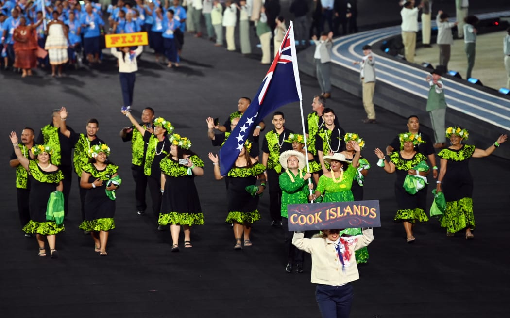 Cook Islands' falg bearers Aidan Zittersteijn and Nooroa Mataio take part with teammates in the opening ceremony for the Commonwealth Games at the Alexander Stadium in Birmingham, central England, on July 28, 2022. (Photo by Glyn KIRK / AFP)