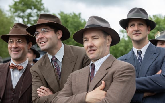 (l-r.) Chris Diamantopoulos stars as Royal Brougham, James Wolk as Coach Bolles, and Joel Edgerton as Al Ulbrickson in director George Clooney’s THE BOYS IN THE BOAT. An Amazon MGM Studios film. Photo credit: Laurie Sparham. © 2023 Metro-Goldwyn-Mayer Pictures Inc. All Rights Reserved.