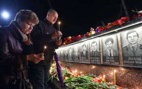 People light candles at the monument to Chernobyl victims in Slavutich, about 50km from the accident site, and where many of the power station's personnel used to live on the 30th anniversary of the disaster.