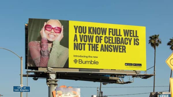 A bright yellow billboard reads: You know full well a vow of celibacy is not the answer