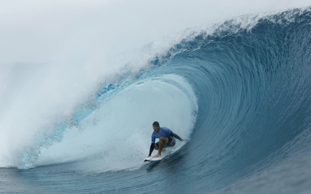 Australia's Jack Robinson gets a barrel in the 7th heat of the men's surfing round 3, during the Paris 2024 Olympic Games, in Teahupo'o, on the French Polynesian Island of Tahiti, on July 29, 2024.
