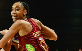 Claire Kersten of the Silver Ferns and Layla Guscoth of England tussle for the balll.