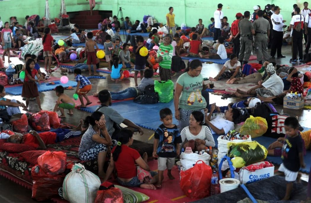 Villagers rest after being evacuated during the raised alert levels for the volcano on Mount Agung in Klungkung regency, Bali.