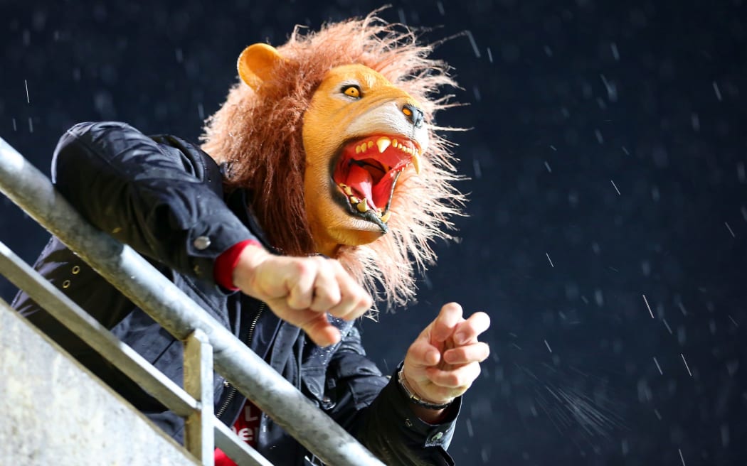 A Lions fan roars his team on.