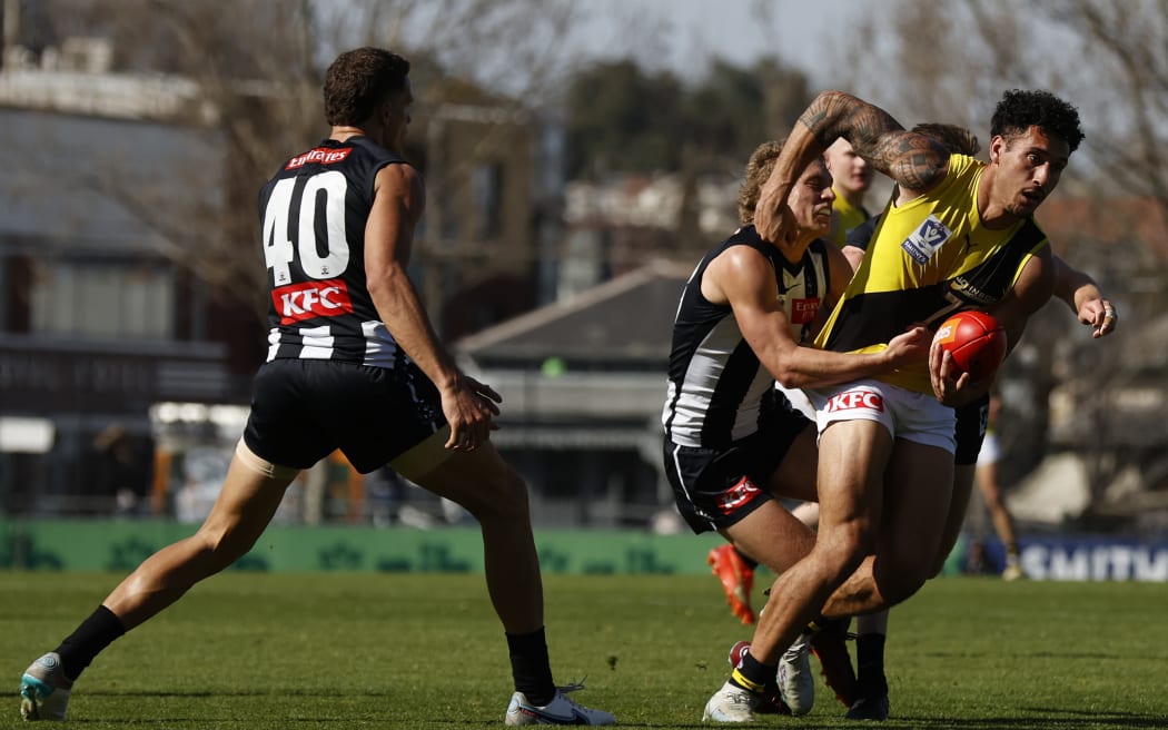 Mykelti Lefau of the Tigers handballs during the VFL Wildcard Round match between Collingwood.