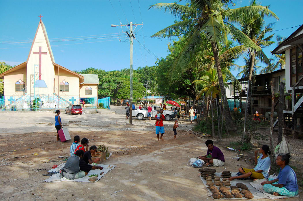 Village market near christian church building, Papua New Guinea