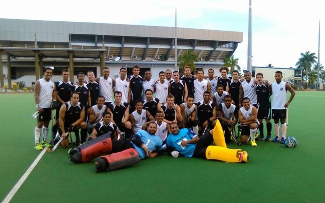Fiji and New Zealand hokcey teams pose after their match at an invitational tournament in Suva.