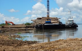 Logs loaded onto barge at Kanduanum on Sepik River; Turubu SABL, East Sepik Province, PNG.