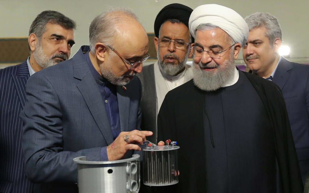 In this file handout photo taken on 9 April, 2019, by the Iranian presidential office, Iranian President Hassan Rouhani (2nd L) listens to the head of Iran's nuclear technology organisation Ali Akbar Salehi during the "nuclear technology day" in Tehran.