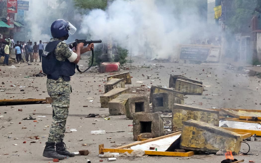 Police use tear gas to disperse student protestors in Bogura on August 4, 2024. (Photo by AFP)