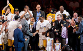 Guard Kobe Bryant of Los Angeles Lakers is presented the Bill Russell NBA Finals MVP Trophy by Bill Russell after the Lakers defeat the Boston Celtics 83-79 and win the NBA championship in Game 7 of the 2010 NBA Finals.