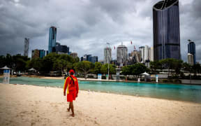 A lifeguard stands watch over a deserted South Bank beach on the first day of a snap lockdown in Brisbane on January 9, 2021.