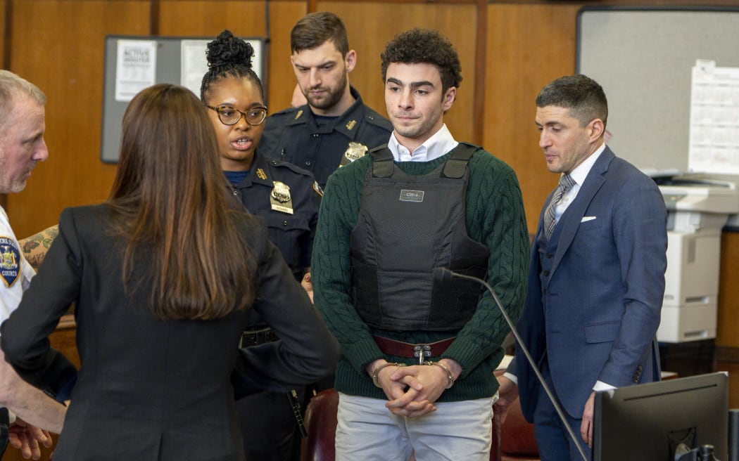 Luigi Mangione, accused killer of US insurance CEO Brian Thompson, attends a hearing at the Manhattan Supreme Court in New York City on February 21, 2025. Mangione is accused of gunning down Thompson in a brazen hit in New York on December 4, 2024, pleaded not guilty to state charges including "terrorist" murder. The suspect is charged in both state and federal court. (Photo by Steven HIRSCH / POOL / AFP)