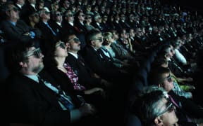 Movie goers watching a 3D film at an IMAX cinema