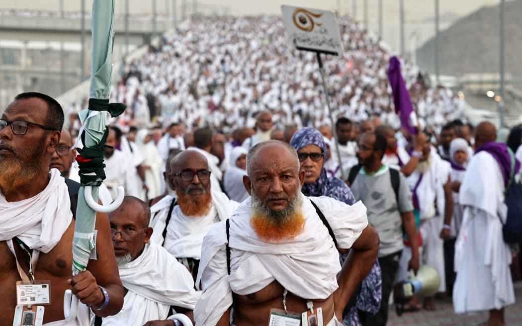 Muslim pilgrims arrive to perform the symbolic 'stoning of the devil' ritual as part of the hajj pilgrimage in Mina, near Saudi Arabia's holy city of Mecca, on June 16, 2024. Pilgrims perform the last major ritual of the hajj, the "stoning of the devil", in western Saudi Arabia on June 16, as Muslims the world over celebrate the Eid al-Adha holiday. (Photo by FADEL SENNA / AFP)