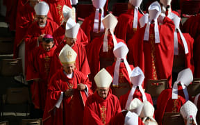Cardinals walk to take their places ahead of the late Pope Francis' funeral ceremony at St Peter's Square at The Vatican on April 26, 2025. (Photo by Mandel NGAN / AFP)