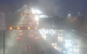 Traffic on the Auckland Harbour Bridge in windy, wet weather.