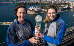 Netball greats Liz Ellis (left) and Irene van Dyk hold the World Cup aloft on the Sydney Harbour bridge.