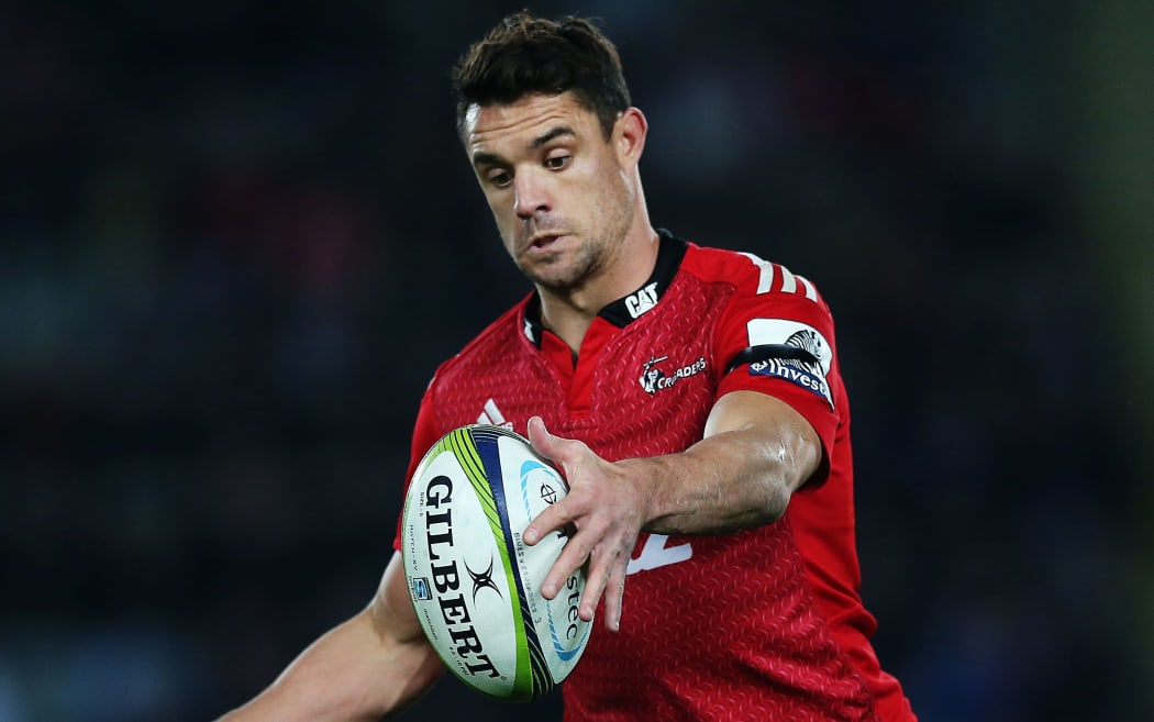 The Crusaders first-five Dan Carter kicks the ball.