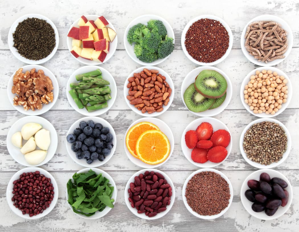 21539836 - large super food selection in white porcelain dishes over distressed white wooden background