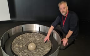 Bruce Aitken of the Len Lye Foundation looks at one of the sound cauldrons.