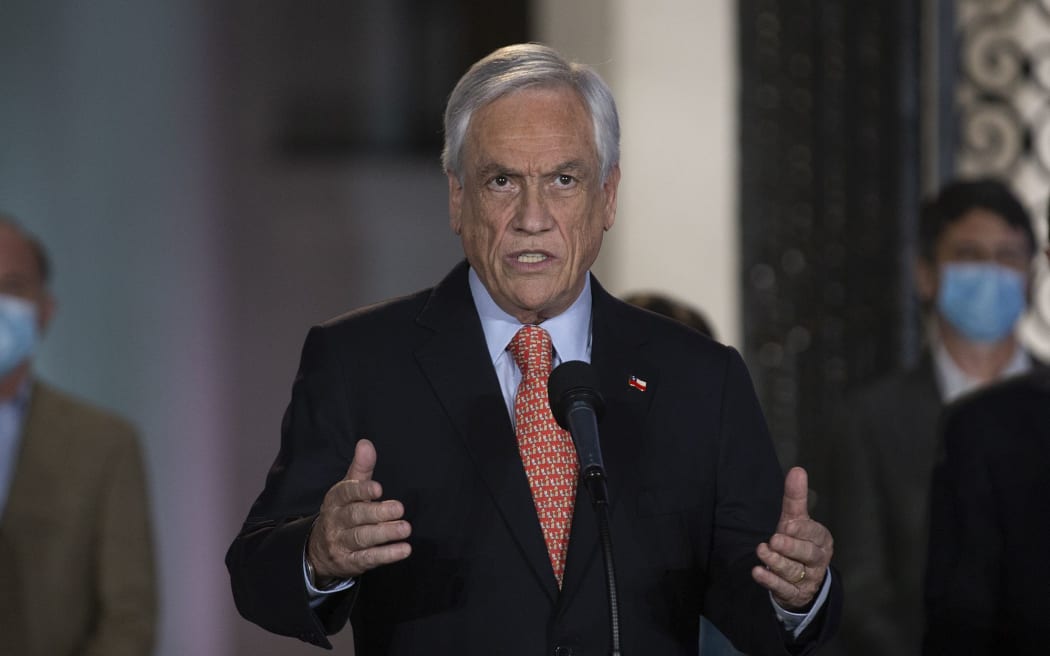 Chile's President Sebastian Pinera speaks at La Moneda presidential palace, in Santiago on October 25, 2020 following the results of the constitutional referendum voting.