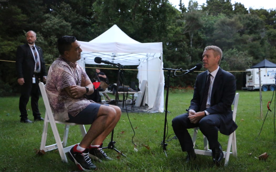 Julian Wilcox speaking with Prime Minister Chris Hipkins from the Waitangi grounds.