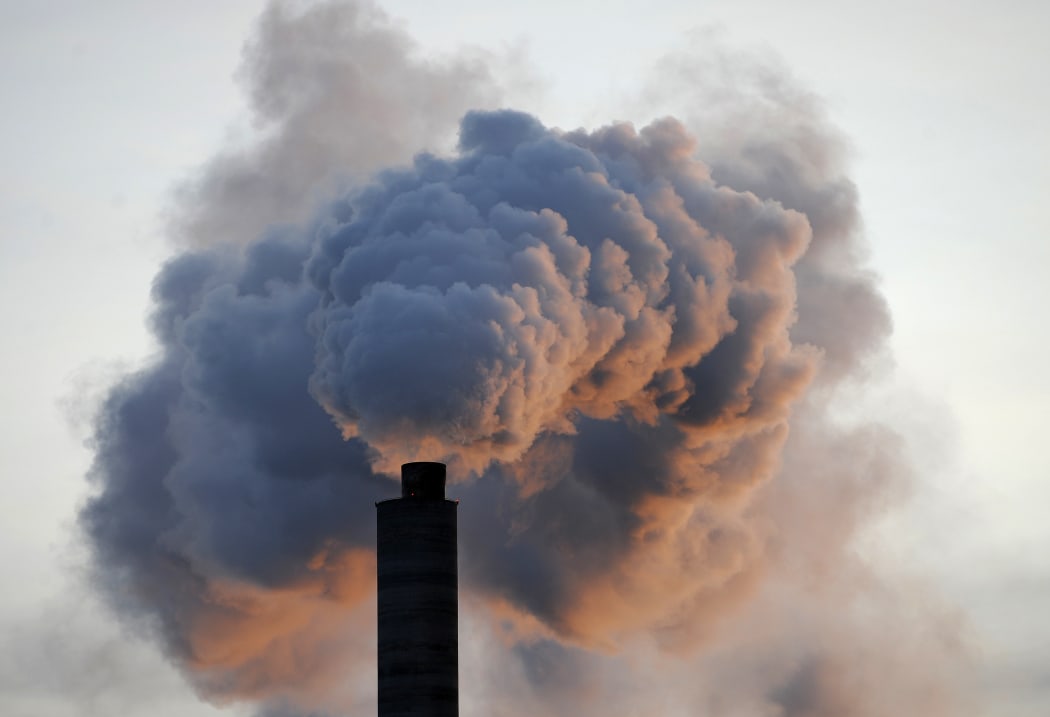 In a file picture taken on 2 January 2009, heavy smoke billows from the chimney of the Kraft paper factory in Pietarsaari, Finland.