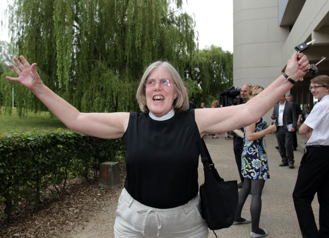 A female member of the clergy celebrates outside the venue after members voted to approve the creation of female bishops at the Church of England General Synod in York, northern England, on July 14, 2014.