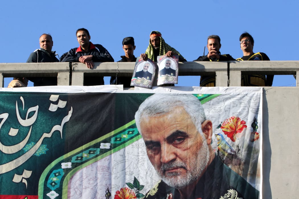 Iranian mourners stand on a bridge during the final stage of funeral processions Qasem Soleimani.