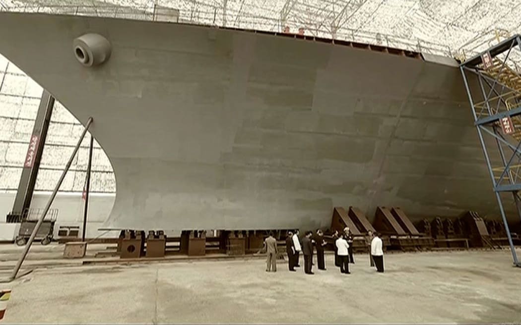 An image from Korean Central Television shows leader Kim Jong Un checking the work on a new warship late last year.
