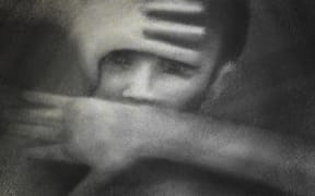 Charcoal sketch of young person shielding face with arms