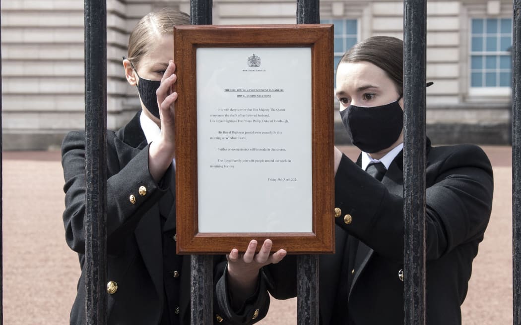 An official notice announcing the death of Britain's Prince Philip, Duke of Edinburgh is placed on the gates of Buckingham Palace in central London on April 9, 2021.