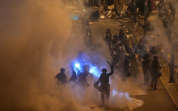 Police fire tear gas at protesters near the government headquarters in Hong Kong on 2 July 2019.