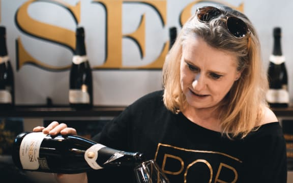 Mel Skinner of Kaikōura winery Esses pours a glass of sparkling wine.