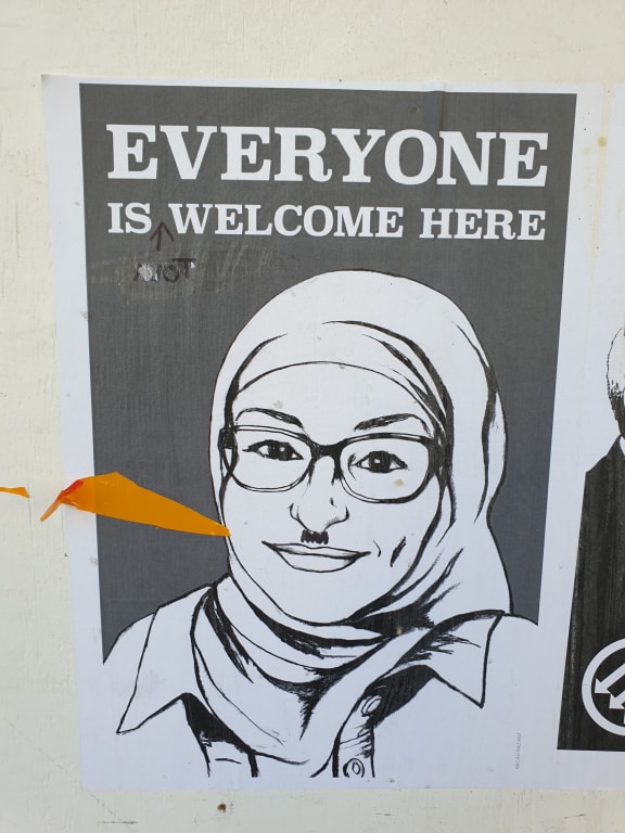 A poster near Dunedin's Exchange was meant to promote unity but has the opposite effect after being defaced.