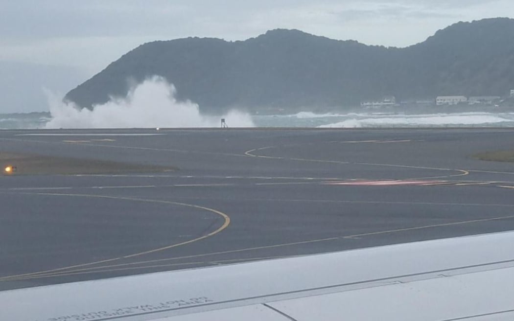 Waves crash near Wellington Airport runway as southerly gales push heavy swells on to the Wellington coast, 30 March 2023.