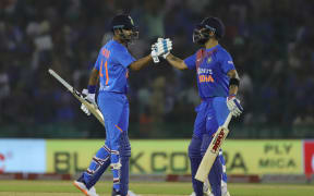 Virat Kohli of India (R) celebrates scoring 50 against South Africa.