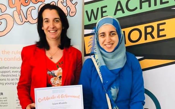Islam getting her certificate of achievement from Puketapapa Local Board Deputy Chair, Julie Fairey.