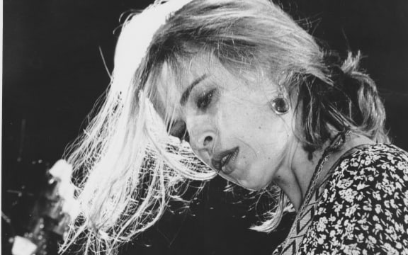 A black and white photograph of Jan Hellriegel playing at the Mountain Rock Festival in 1993.