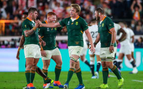 Pieter-Steph du Toit (C) celebrates a Springboks try with Malcolm Marx.