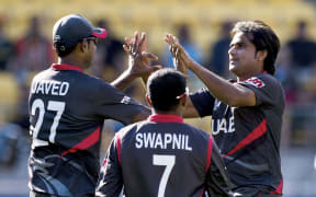 Members of the UAE cricket team celebrate.