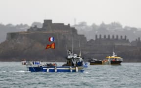 ALTERNATIVE CROP - French fishing boats protest in front of the port of Saint Helier off the British island of Jersey to draw attention to what they see as unfair restrictions on their ability to fish in UK waters after Brexit, on May 6, 2021.