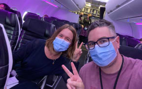 RNZ journalist Tess Brunton and videographer Simon Rogers on board the first flight from Auckland to Sydney after the trans-Tasman bubble opened.
