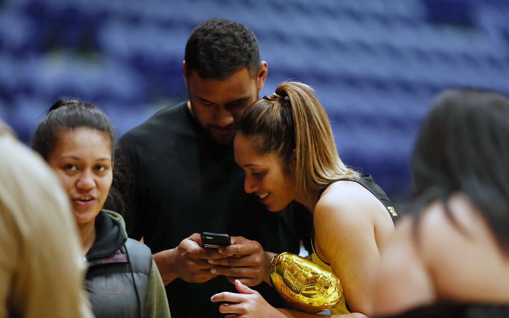 Rugby player Patrick Tuipulotu with Silver Fern Phoenix Karaka