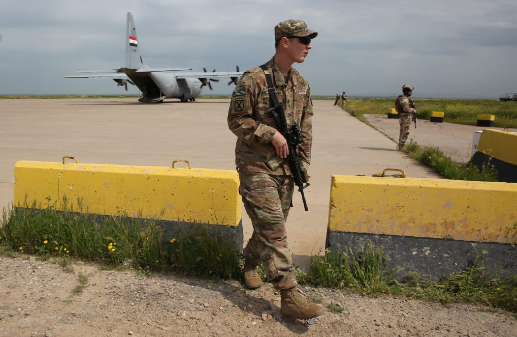 A US soldier walks at the Qayyarah air base, where US-led troops in 2017 had helped Iraqis plan out the fight against the Islamic State in nearby Mosul in northern Iraq, before a planned US pullout on March 26, 2020.