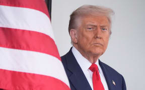 President Donald Trump waits to greet Argentina's President Javier Milei, as he arrives at the White House on 14 October 2025 in Washington.