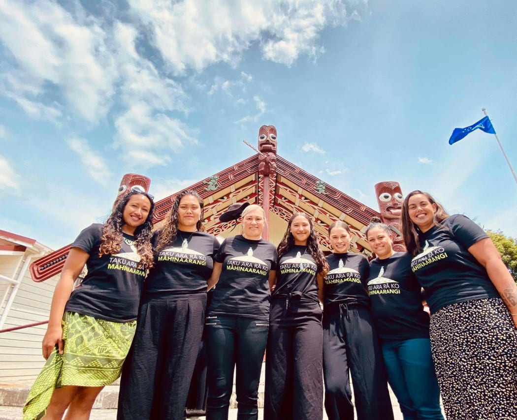 from Left-Right is in front of the Wharenui at Rāwhitiroa marae. Names (Left to right) are Ngahuia Kopa, Kyea Watene-Hakaria, Lisa Begbie, Tyra Begbie, K-lee Begbie, Arahia Moeke, Naomi Simmonds.