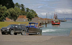 Calling it a day as fishermen bring their boat into the port of Gisborne.
