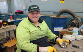 A photo of Greg Duncan breaking power meters down into recyclable e-scrap